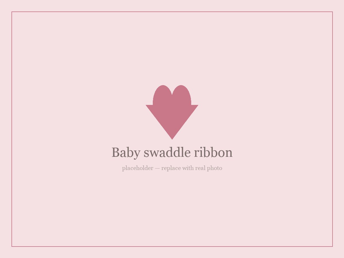 Baby swaddle ribbon with an embroidered name, styled for a hospital newborn photo