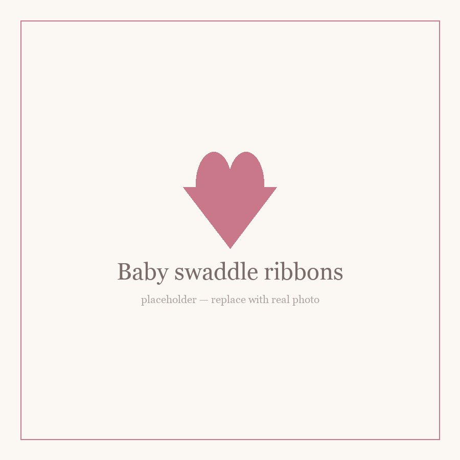 Personalized baby swaddle with an embroidered name and matching ribbon bow
