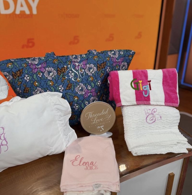 Monogrammed quilted tote, personalized beach towel, and embroidered burp cloth displayed on the Texas Today set